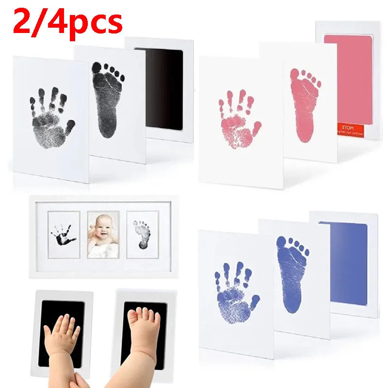 A set of four baby handprint and footprint kits showing various prints in pink, gray, and blue on white cardstock.