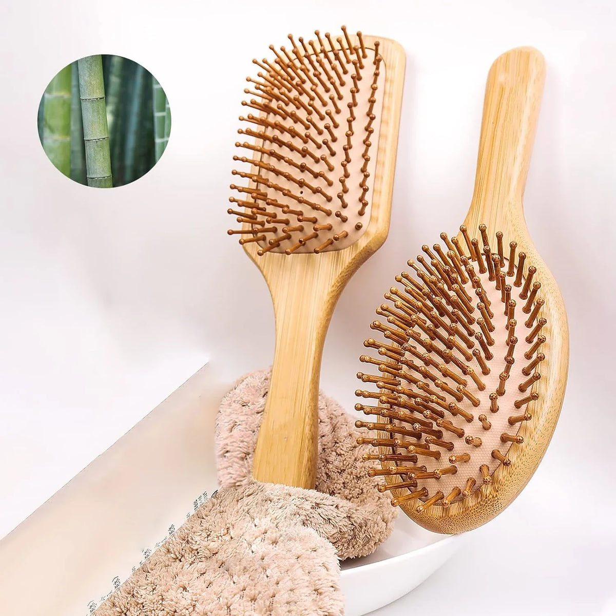 A wooden hair brush with natural bamboo bristles is shown next to a light pink exfoliating sponge.