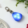 A pendant light blue glass charm attached to a silver clasp, set against a white background.