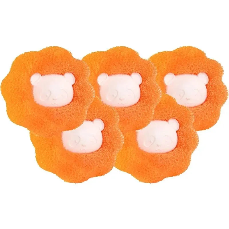 Several orange, porous balls designed for reusable pet hair and lint removal.