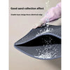 A hand is pouring sand into a dark gray double-layer cat litter mat, demonstrating its good sand collection effect.