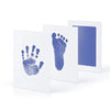 White framed prints showing blue handprint and footprint imprints on paper
