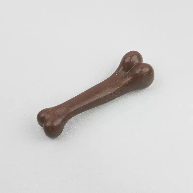 A brown natural wood chew toy for dogs shaped like a bone, viewed from the side.