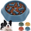 A blue anti-choking slow feeder dog bowl filled with kibble and various puzzle designs.