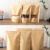 Three reusable kraft paper zipper bags filled with dried ingredients are displayed on a wooden shelf.