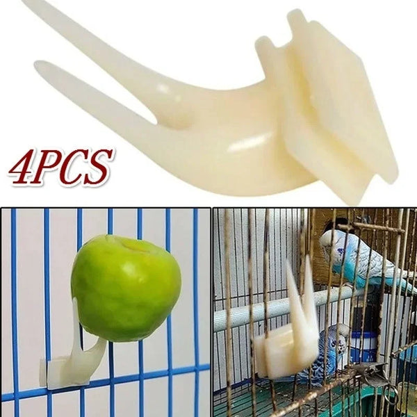 Four white plastic fruit forks used as a bird feeding rack for fruit