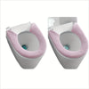 A pair of plush pink non-slip toilet seat covers shown from the front.
