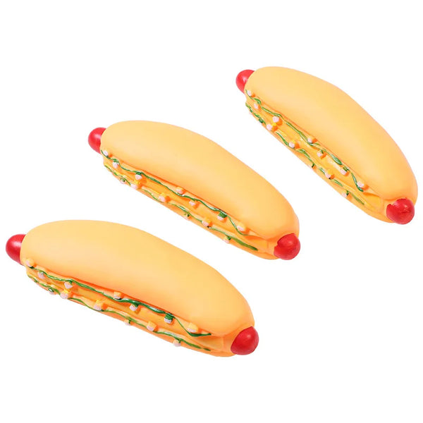 A large hot dog squeaky chew toy for dogs, featuring a yellow sausage with visible fillings and red ends.