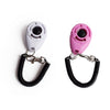 Une paire de clickers d'entraînement pour animaux, un blanc et un rose, avec des sangles ajustables noires.