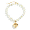 A delicate gold chain choker necklace featuring multiple strands of white pearls and a heart-shaped pearl pendant.