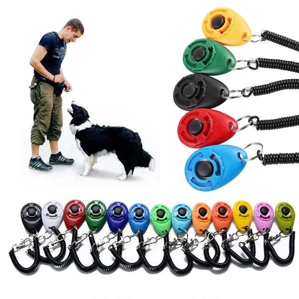 A collection of colorful pet training clickers with black wrist straps and metal clasps.