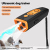 A black ultrasonic dog trainer device emitting a blue light, shown in use on a dog.