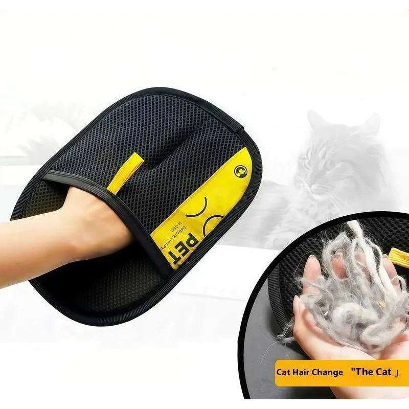 A hand is using a black pet hair remover glove with yellow accents to clean cat hair.