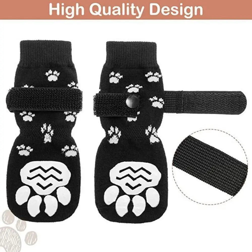Black knitted dog socks with white paw prints and adjustable straps for dog protection