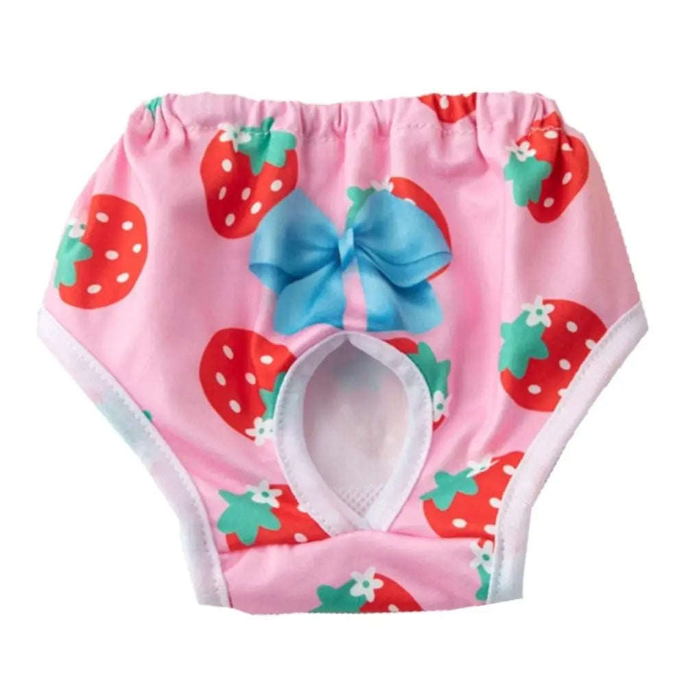 Pink reusable dog physiological pants with a strawberry pattern and a blue bow
