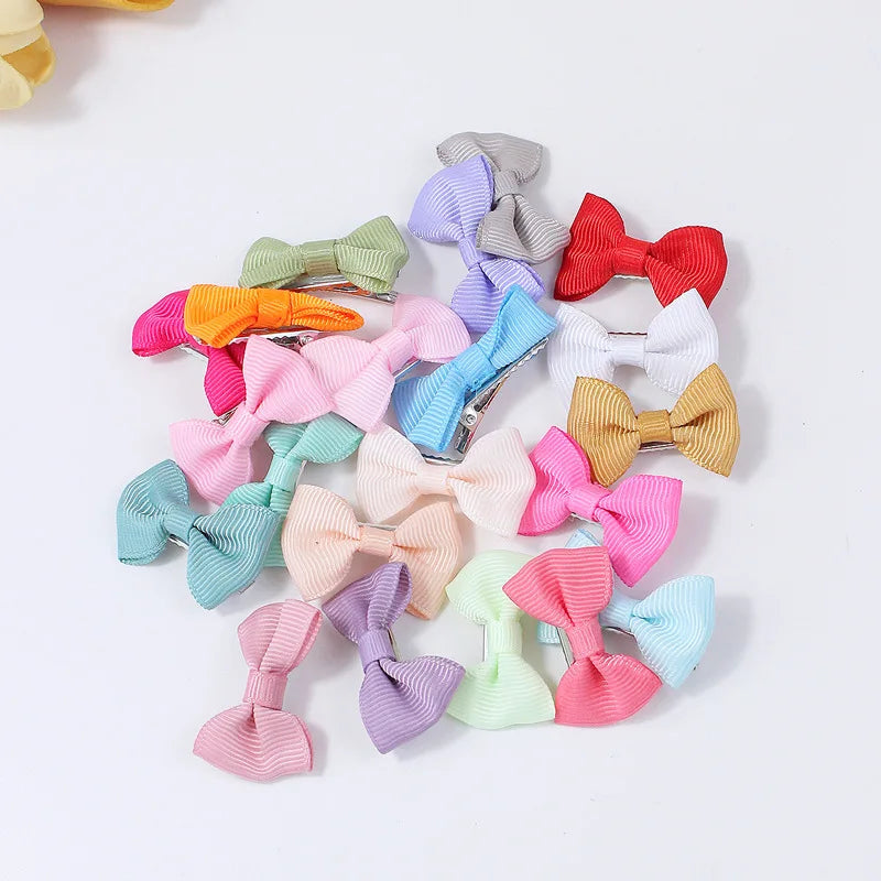 A collection of colorful pet hair clips in various shades including pink, green, purple, and red.