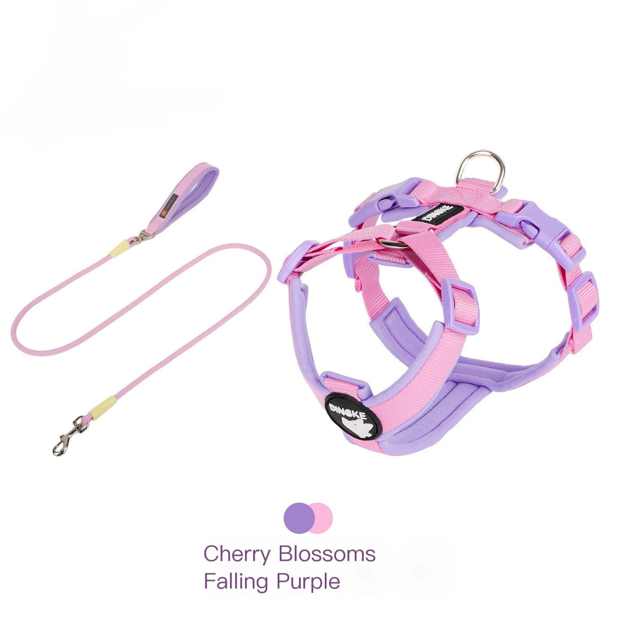 A purple and pink breathable no-pull dog harness with reflective strips for a dog.