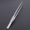 Stainless steel aquarium cleaning tweezers shown diagonally on a dark gray surface.