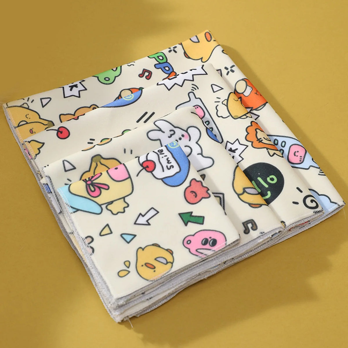 A stack of self-adhesive pet swaddles featuring colorful, cartoon-style designs for nail clipping and restraint.