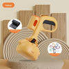 A yellow portable pet poop picker scooper with an ergonomic handle is shown on a light surface.