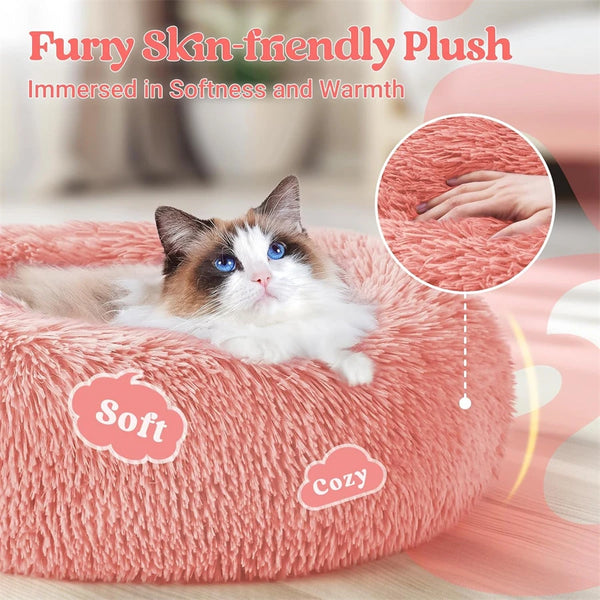 A fluffy pink plush bed with a cat resting on it, emphasizing softness and warmth.