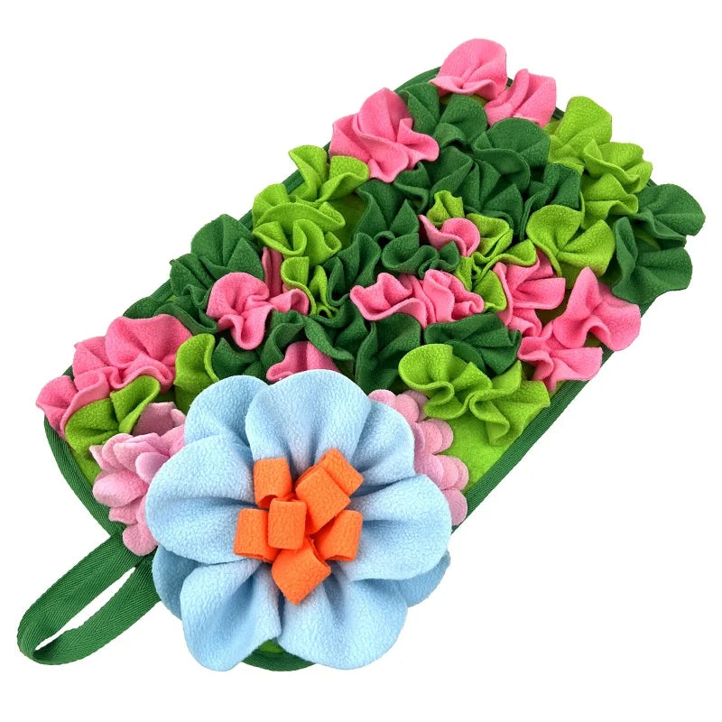 A colorful fabric mat featuring pink and green floral shapes for interactive pet foraging.