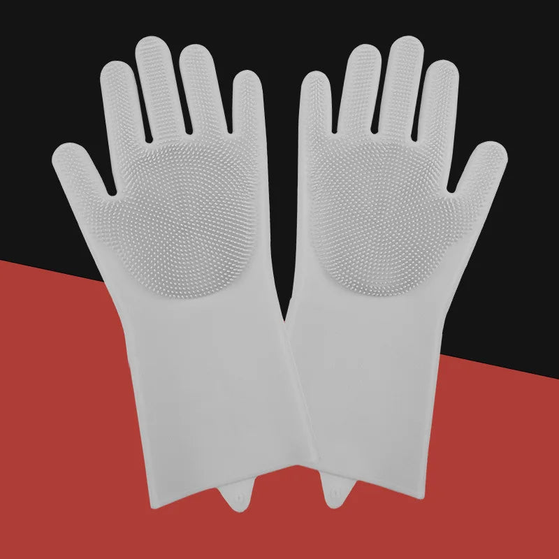 A pair of white pet grooming gloves for dogs and cats lying on a red surface.