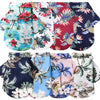 A collection of dog shirts featuring various Hawaiian leaf prints in red, blue, and white patterns.
