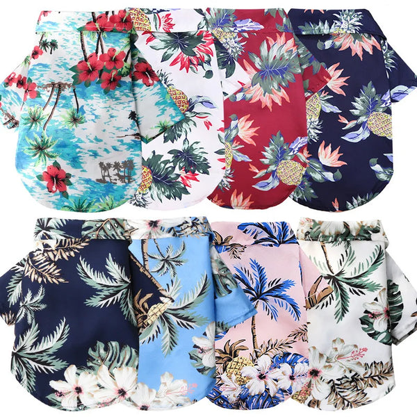 A collection of dog shirts featuring various Hawaiian leaf prints in red, blue, and white patterns.