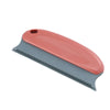 A reusable pet hair remover brush with a pink and gray handle and a textured cleaning blade.