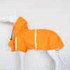 Orange waterproof dog raincoat with a hood and reflective piping displayed on a white mannequin.