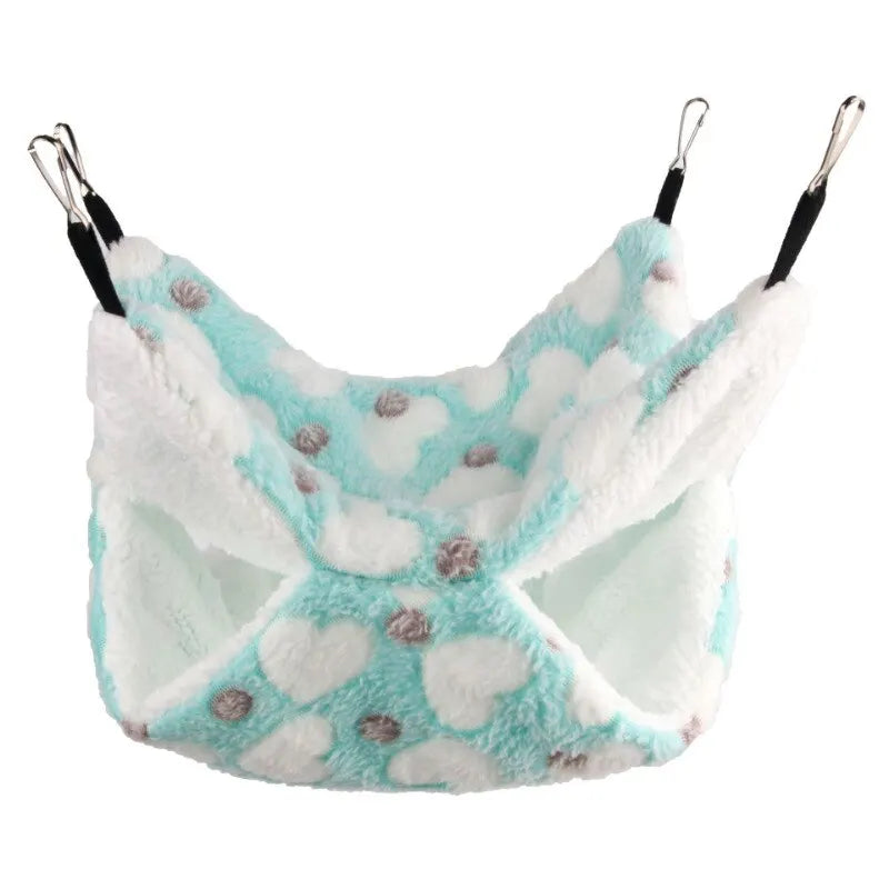 A white and light blue plush pet hammock with a cloud pattern for small animals