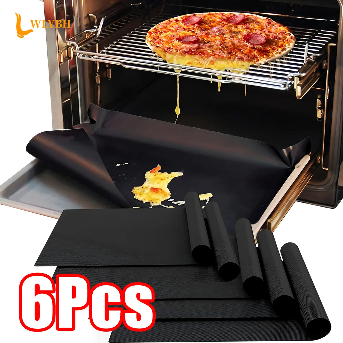 Six black reusable non-stick oven and grill liners are shown inside an oven with a pizza cooking on a rack.