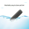 A gray pumice pet hair remover brush submerged in clear water.
