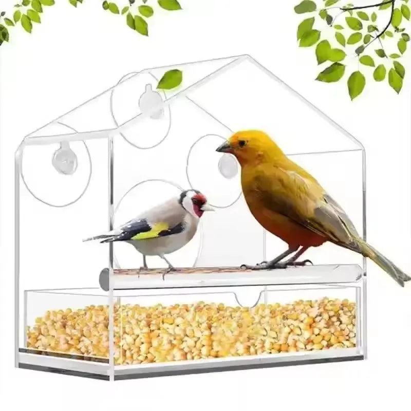 Clear acrylic bird feeder with suction cups designed for window mounting, featuring a feeding tray.