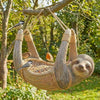 A wooden tree hugger bird feeder suspended from a branch, with a small bird perched inside.