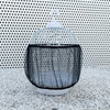 A white mesh bird cage with a black fabric guard is displayed on a light-colored gravel surface.