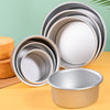 A stack of round aluminum cake pans and a single pan are displayed on a yellow surface.