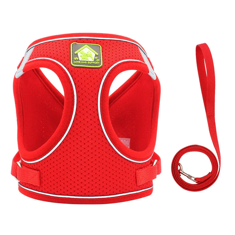Red adjustable mesh dog harness with reflective strips and a detachable leash