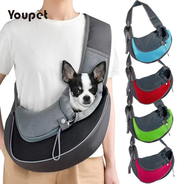 A gray breathable pet sling carrier for dogs and cats being worn by a person.
