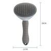 A gray pet hair removal brush with massage pins shown vertically.