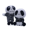 A plush toy of a cartoon skeleton dog with black and white features and striped clothing.