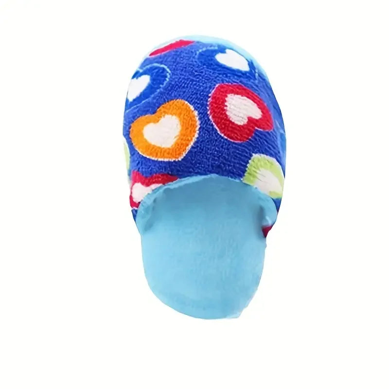 A blue fabric slipper with a pattern of colorful hearts and flowers.