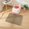 A pink and white double-layer cat litter mat with a waterproof base is placed on a light wood floor.