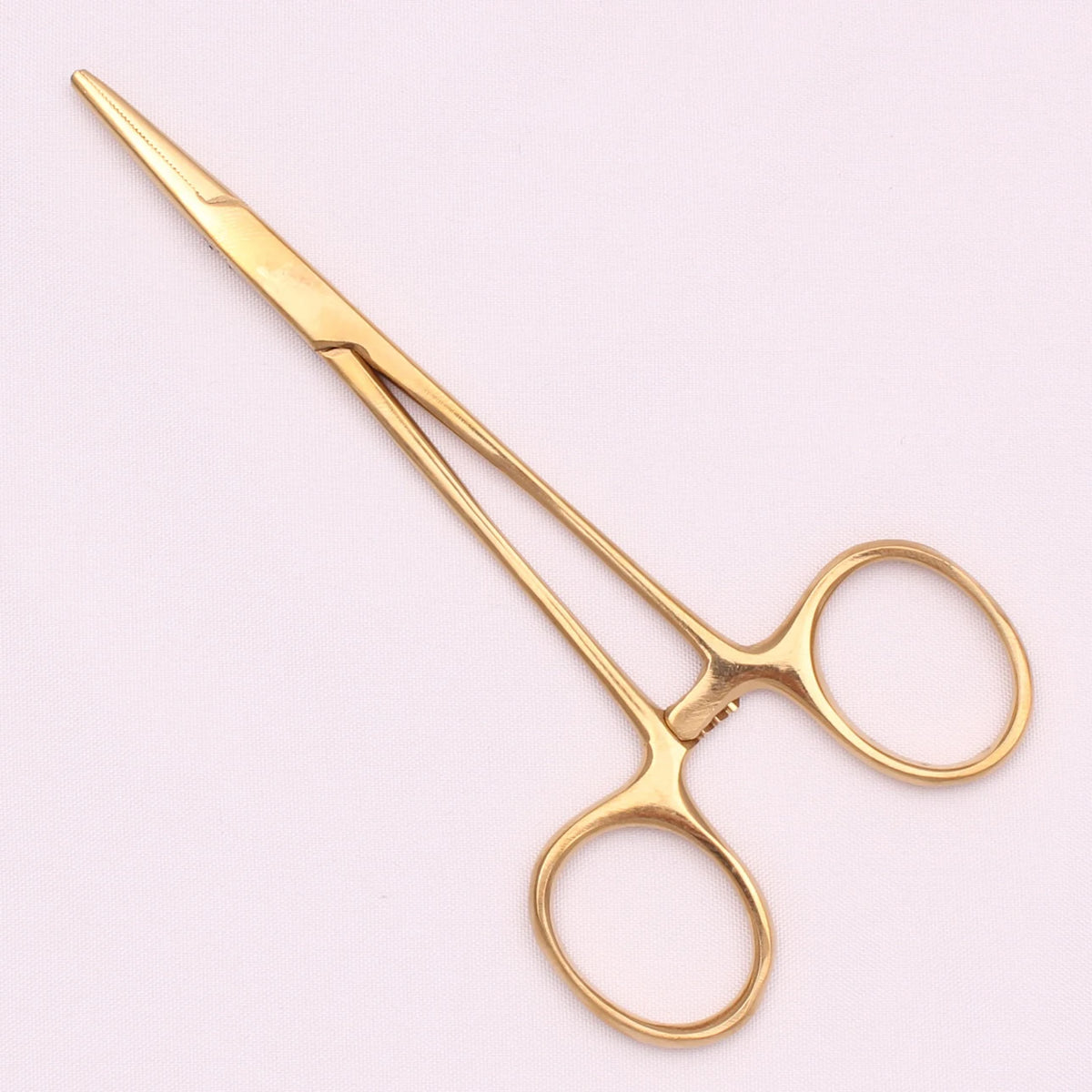 A pair of gold-toned surgical forceps with fine tips and circular jaws.
