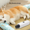 A fluffy orange and white dog is resting on a mat next to a white pet nail grinder device.