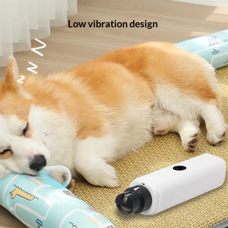 A fluffy orange and white dog is resting on a mat next to a white pet nail grinder device.