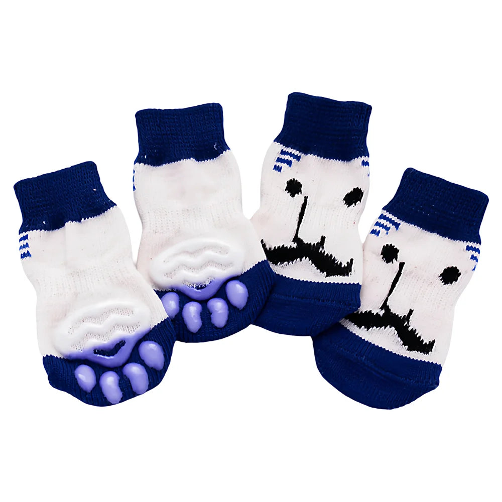 A pack of four anti-scratch cotton pet socks for small dogs and cats, featuring a white face design on dark blue fabric.