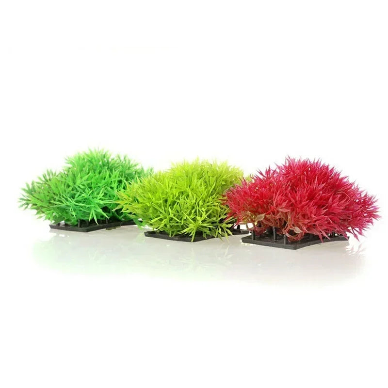 Three vibrant artificial aquarium plants in shades of green, lime green, and red