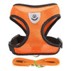 Orange pet harness and leash set for dogs and cats with a paw print emblem